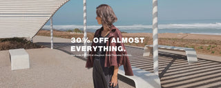 Woman standing on a beach with promotional text overlay