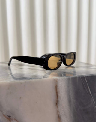 Black frame sunglasses with brown lenses and squoval shape
