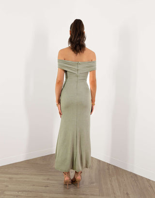 Model in green off shoulder fitted midi dress with gold buckle detail