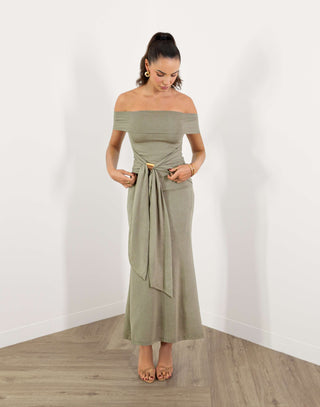 Model in green off shoulder fitted midi dress with gold buckle detail