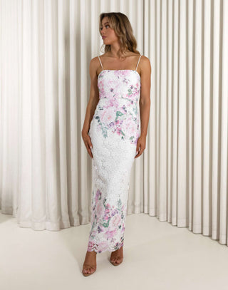 Woman wearing a floral dress standing against a white curtain background Aleyse floral lace maxi dress with back split