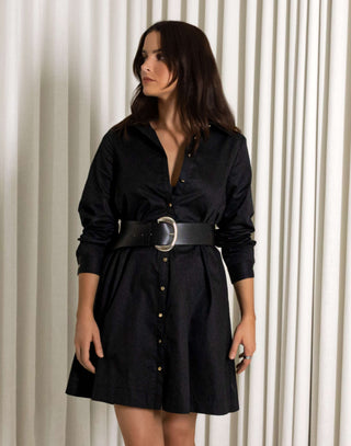 Woman wearing a black dress with a belt against a white curtain background Black collared long sleeve a line mini dress 