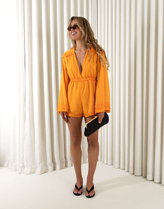 Orange ruffle playsuit with V neckline and flared long sleeves