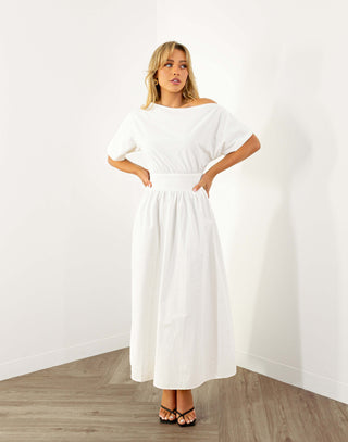 Model wearing white off shoulder midi dress with fitted waist