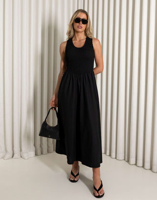 Black midi dress with shirred bodice and side split worn by model