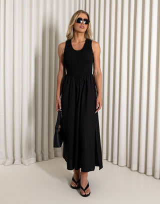 Black midi dress with shirred bodice and side split worn by model