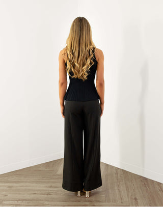 Black peplum knit top with statement buttons, bra friendly