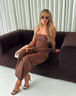 Model wearing strapless brown pinstripe top with shirred back