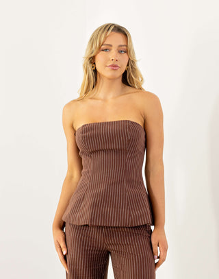 Model wearing strapless brown pinstripe top with shirred back