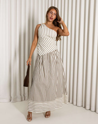 Woman wearing a brown striped set against a white curtain background
Cream and brown stripe matching top and maxi skirt set