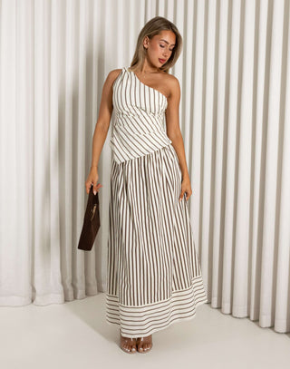 Woman wearing a brown striped set against a white curtain background
Cream and brown stripe matching top and maxi skirt set