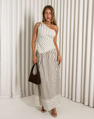 Woman wearing a brown striped set against a white curtain background
Cream and brown stripe matching top and maxi skirt set
