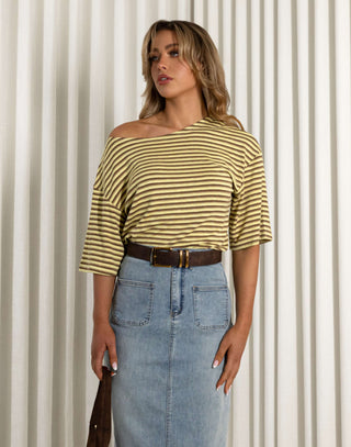 Woman wearing a striped yellow and white top and blue denim skirt against a neutral background Martin stripe versatile off shoulder long length top