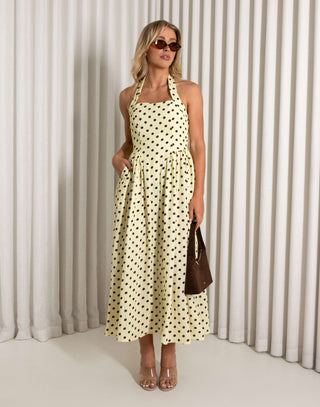 Yellow polka dot halter neck midi dress with pockets worn by model