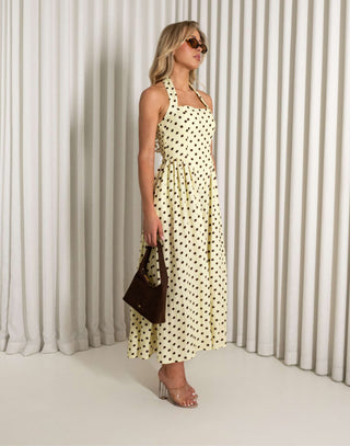 Yellow polka dot halter neck midi dress with pockets worn by model