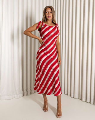 Woman wearing a red and white striped dress against a white curtain background Mike red and white striped bias-cut midi dress
