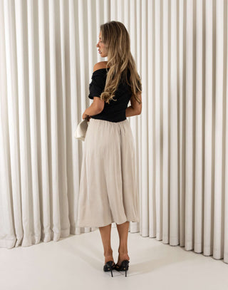 Two tone beige and black off shoulder midi dress with ribbed top and flowing skirt