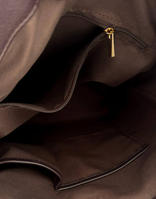 brown handbag on a marble surface with a neutral background