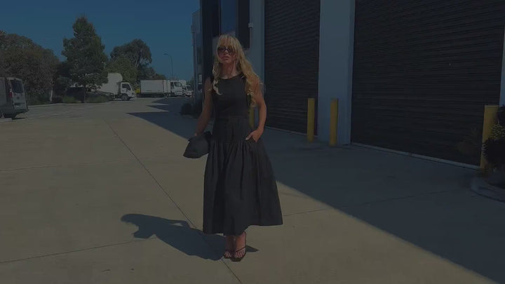 Model wearing the Eddie black dress, shown posing outdoors from different angles.