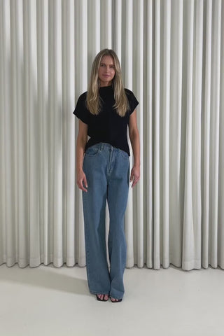 Model showing the Garrett Black Top and Benjy denim jeans from the front, side and back to demonstrate its fit and movement.
