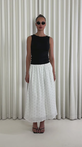 Black polka dot two-tone midi dress with fitted gathered bust