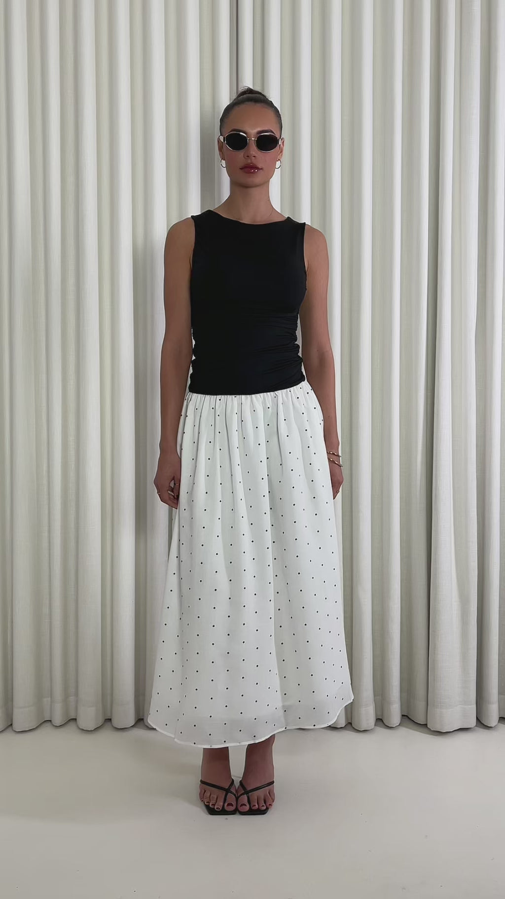 Black polka dot two-tone midi dress with fitted gathered bust