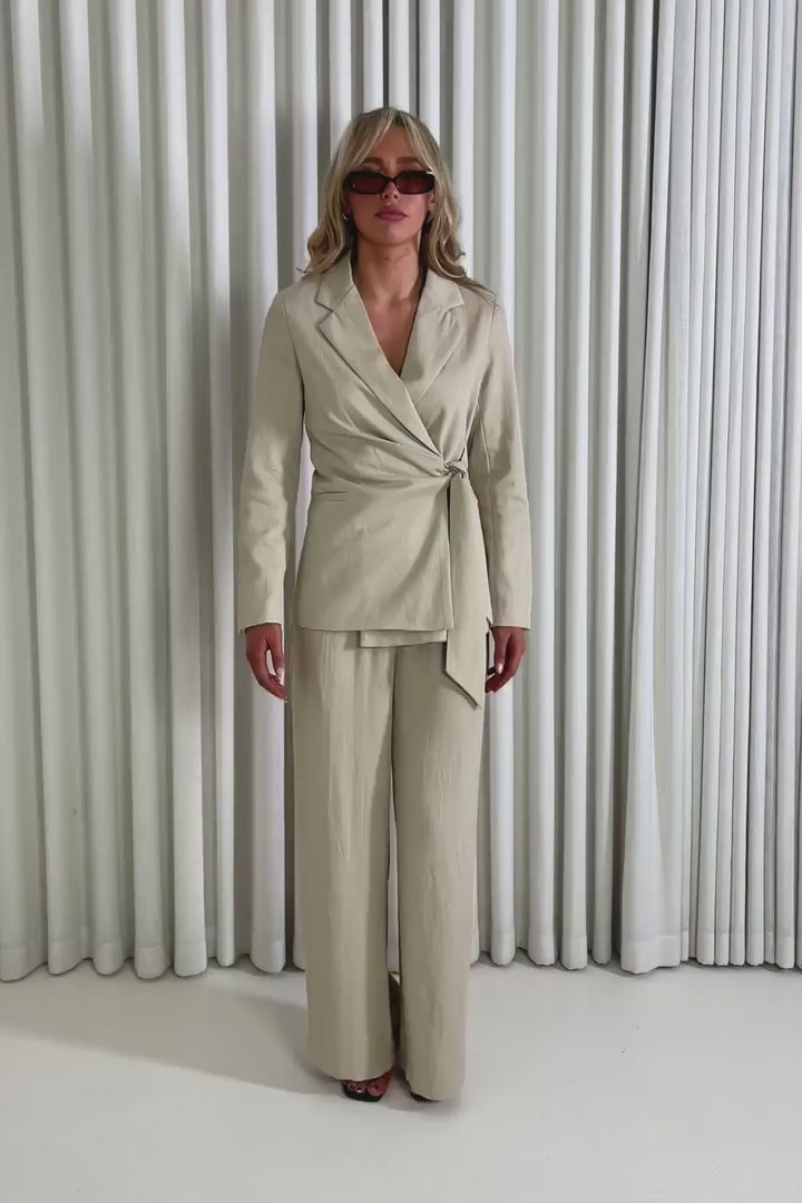 Model showing the Isabella tie blazer and matching Isabella pants from the front, side and back to demonstrate its fit and movement.