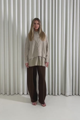 Model showing the Maxwell Oversized Beige Knit from the front, side and back to demonstrate its fit and movement
