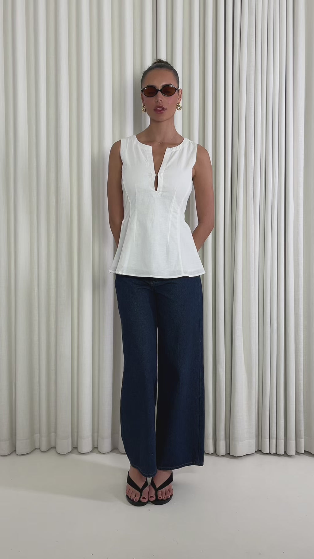 White linen-cotton sleeveless top with V neck, tailored waist and peplum