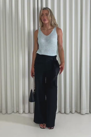 Model showing the baby blue Ashleigh knit top and Gabrielle pants from the front, side and back to demonstrate its fit and movement.