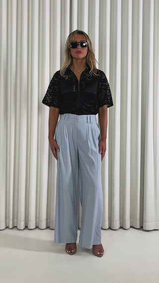 Black-relaxed-lace-shirt-with-collar-short-sleeves-and-button-front & Blue-wide-leg-high-waist-dress-pants-with-side-pockets