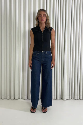 Black sleeveless collared top with two way gold zip and darts