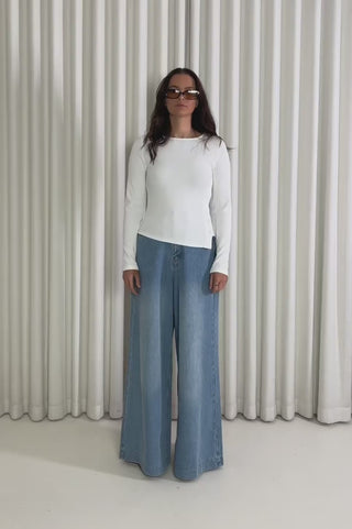 Model showing the Lauren Button White Top from the front, side and back to demonstrate its fit and movement.