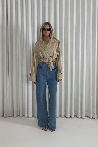 Model showing the Justin Cropped Trench Jacket from the front, side and back to demonstrate its fit and movement.