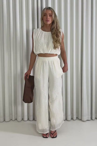 Model showing the cream Verity lace top and matching pants from the front, side and back to demonstrate its fit and movement.