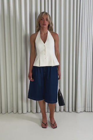 Model showing the cream Sabrina Halter Top and Jack Denim Shorts
 from the front, side and back to demonstrate its fit and movement.