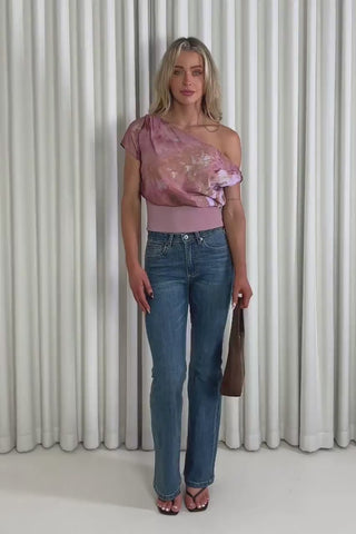 Model showing the pink off shoulder Anna top and Daniel jeans from the front, side and back to demonstrate its fit and movement.