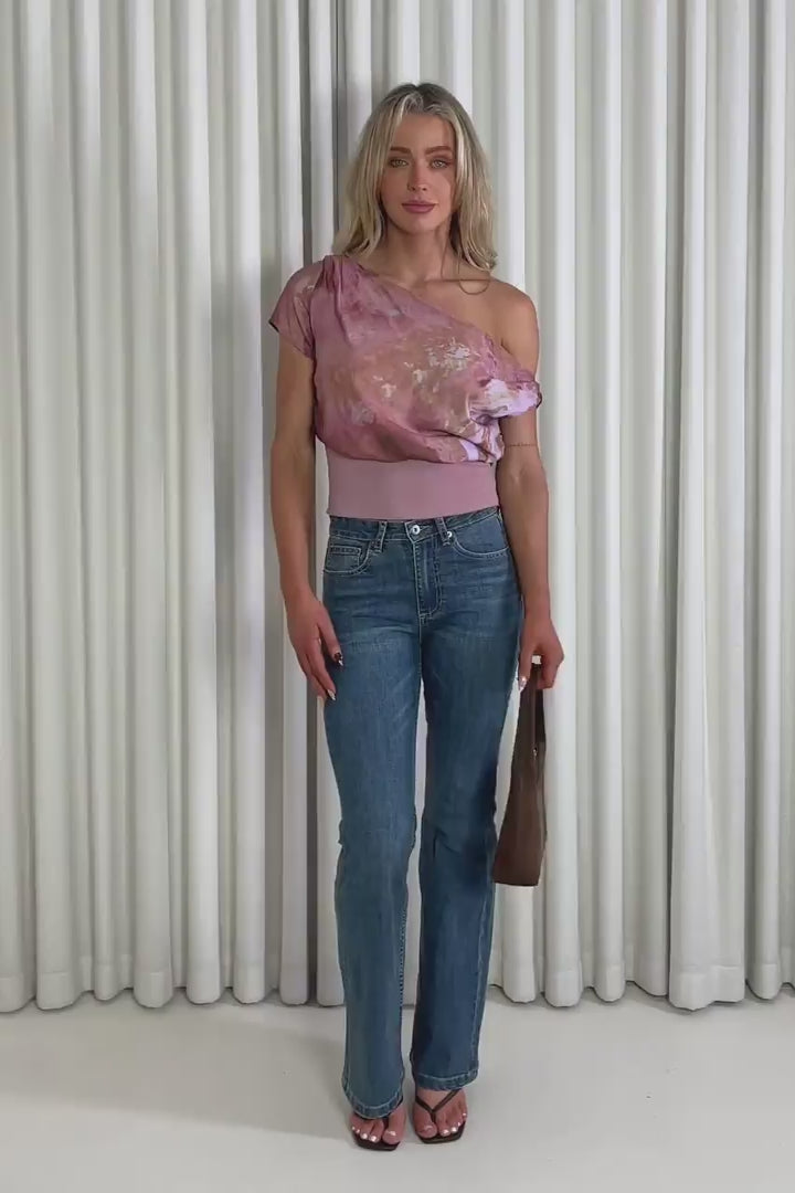 Model showing the pink off shoulder Anna top and Daniel jeans from the front, side and back to demonstrate its fit and movement.