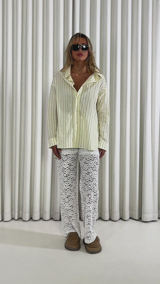 White-high-waist-lace-straight-leg-pants-with-shorts-lining & Yellow-oversized-cotton-button-up-shirt-with-gathered-back-detail