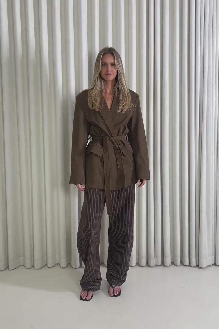Model showing the Jordan Tie Brown Blazer from the front, side and back to demonstrate its fit and movement.