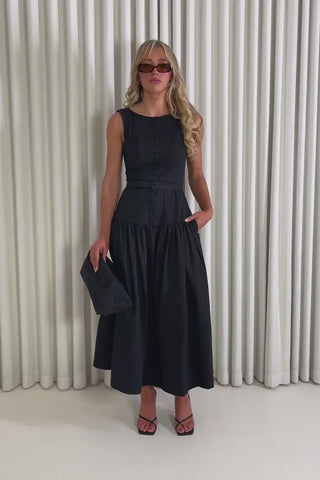 Model showing the black Eddie midi dress from the front, side and back to demonstrate its fit and movement.