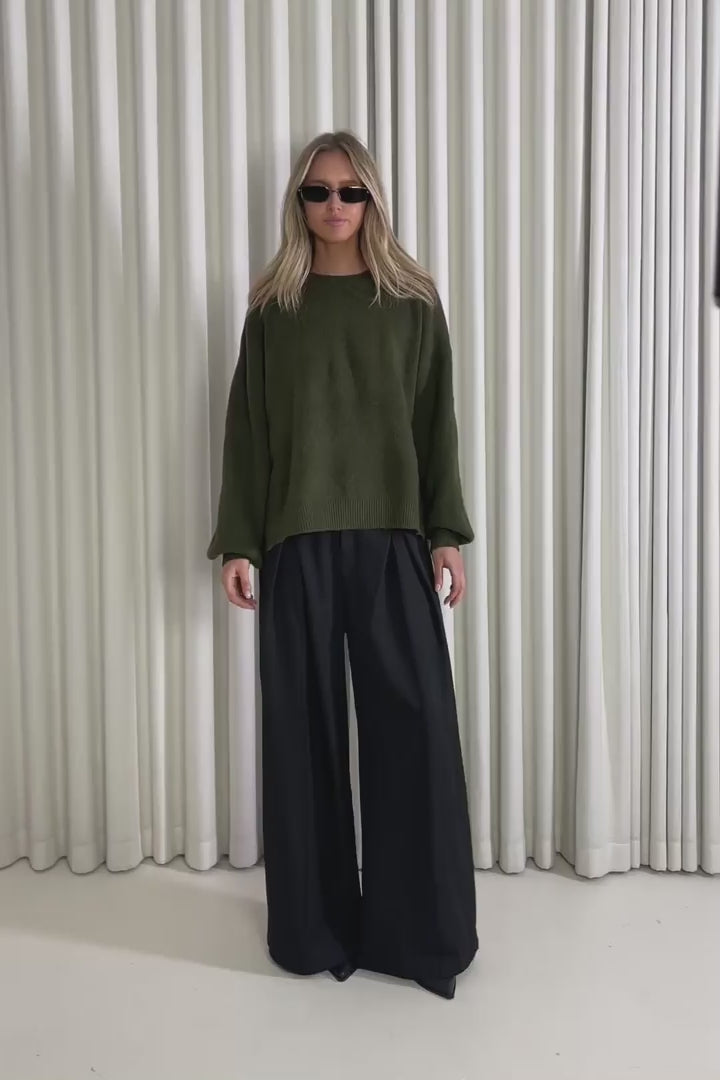 Model showing the Bessette Green Knit from the front, side and back to demonstrate its fit and movement.