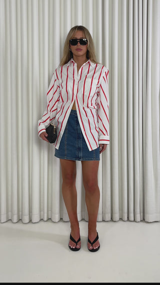 Red striped relaxed rayon button-up shirt with collar and patch pocket & Mid blue high-waist denim mini skirt with flap pockets and zip front