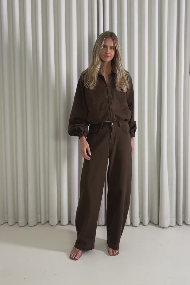 Model showing the Nigel Bomber Jacket and nigel brown pants from the front, side and back to demonstrate its fit and movement.
