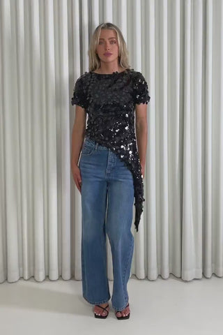 Model showing the black sequin Dakota top and Charly jeans from the front, side and back to demonstrate its fit and movement.