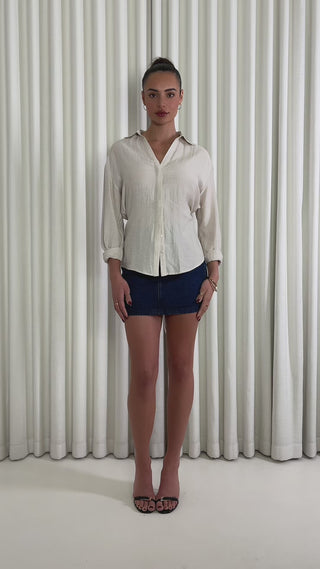 Oat linen-blend relaxed button-up shirt with waist tie and long sleeves Dark denim high-waist fitted mini skirt with button zip and pockets