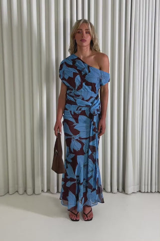 Model showing the floral Geoff midi dress from the front, side and back to demonstrate its fit and movement.