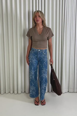 Model showing the Freddy floral denim jeans from the front, side and back to demonstrate its fit and movement.