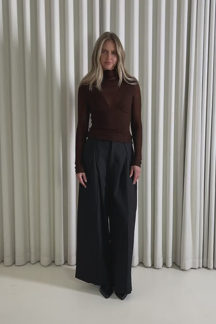 Model showing the Andy Off Shoulder Knit Top from the front, side and back to demonstrate its fit and movement.