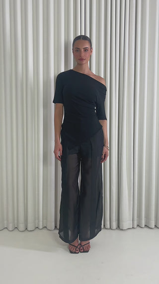 Black high waisted pants with sheer organza legs and shorts lining & Black off shoulder fitted top with gathered sides and asymmetrical hem